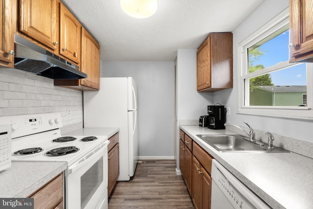 436 Heather Ridge Dr, Frederick, MD 21702 - kitchen with under cabinet range hood, white appliances, a sink, wood finished floors, and light countertops