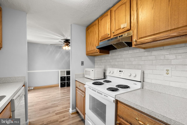 436 Heather Ridge Dr, Frederick, MD 21702 - kitchen with under cabinet range hood, light countertops, a ceiling fan, and white appliances