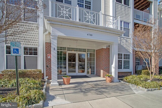 doorway to property featuring french doors and a balcony