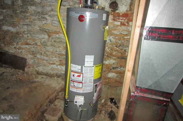 utility room with gas water heater