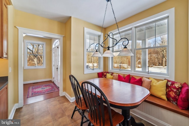 tiled dining room featuring breakfast area