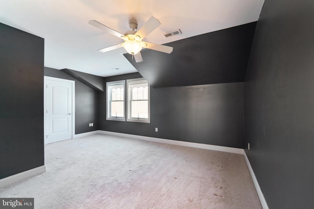 bonus room with ceiling fan, lofted ceiling, and light carpet