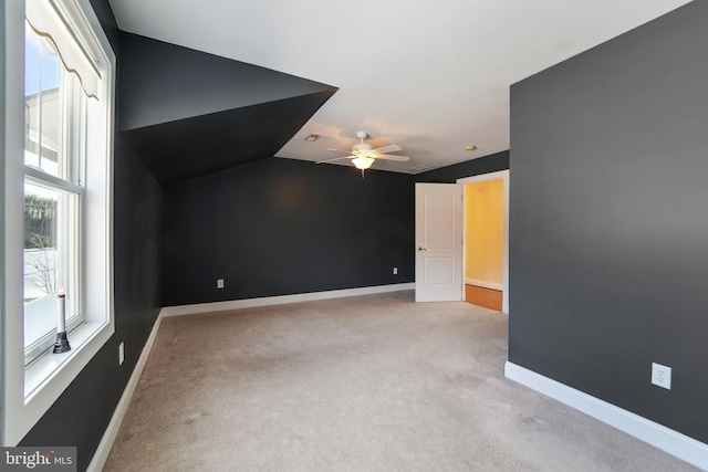 additional living space with ceiling fan, light carpet, and vaulted ceiling