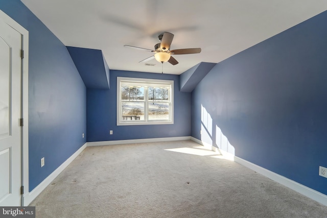 additional living space featuring ceiling fan and light carpet