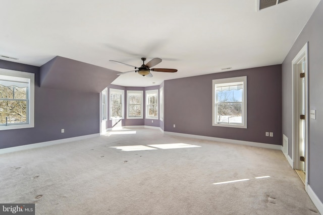 additional living space with light carpet and ceiling fan