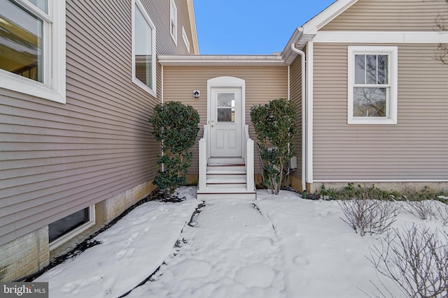 view of snow covered property entrance