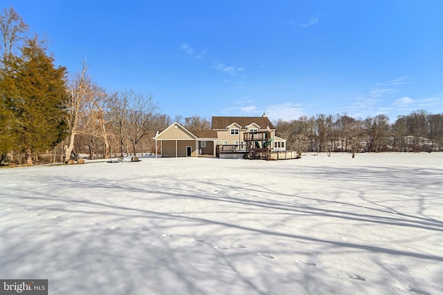 snow covered house with a deck