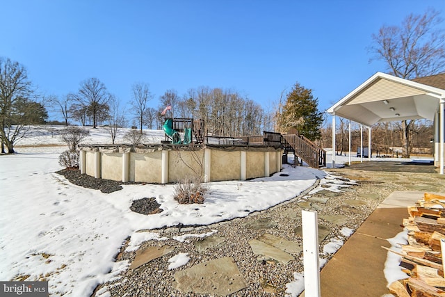 yard layered in snow featuring a covered pool