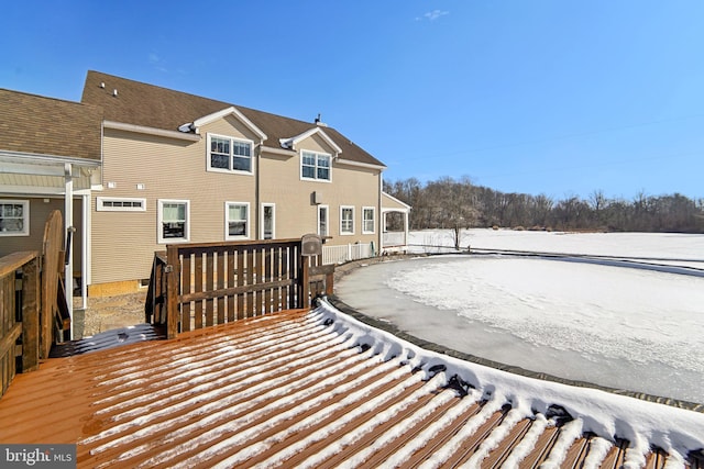 snow covered back of property featuring a deck and central air condition unit