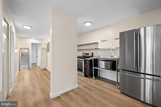 kitchen featuring stainless steel appliances and light hardwood / wood-style flooring