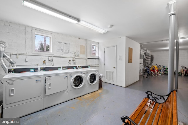 clothes washing area with washing machine and clothes dryer