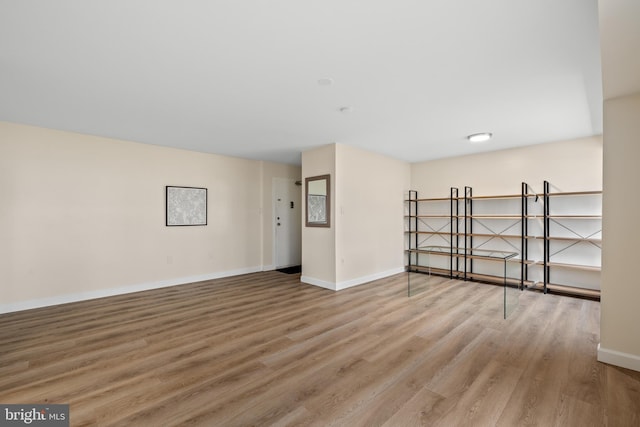 unfurnished room with hardwood / wood-style flooring