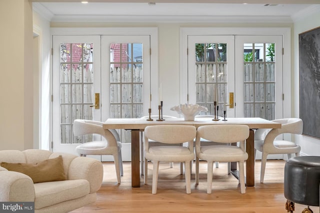 dining room featuring light wood-type flooring and ornamental molding