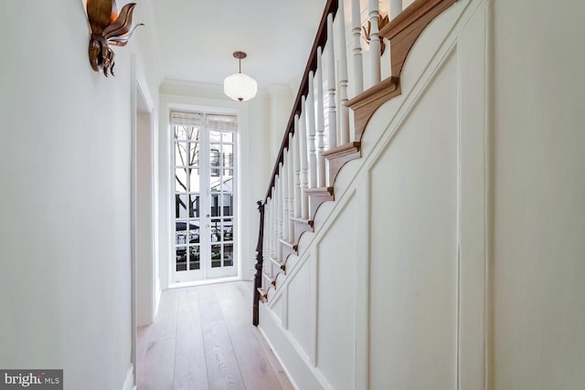 interior space featuring light hardwood / wood-style flooring, french doors, and crown molding