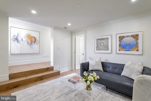 living room with ornamental molding and light hardwood / wood-style flooring