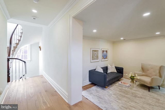 hallway featuring light wood-type flooring and crown molding