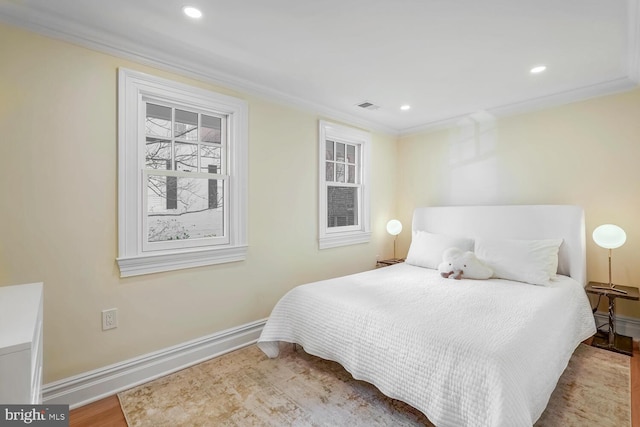 bedroom featuring ornamental molding and hardwood / wood-style flooring