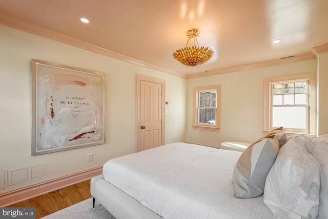 bedroom with hardwood / wood-style floors and crown molding