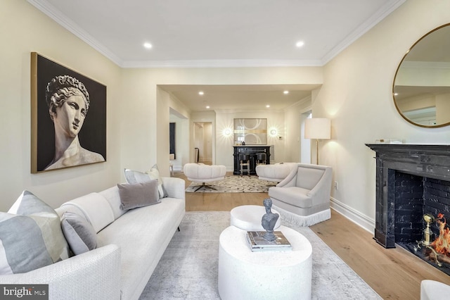 living room featuring ornamental molding and light hardwood / wood-style flooring