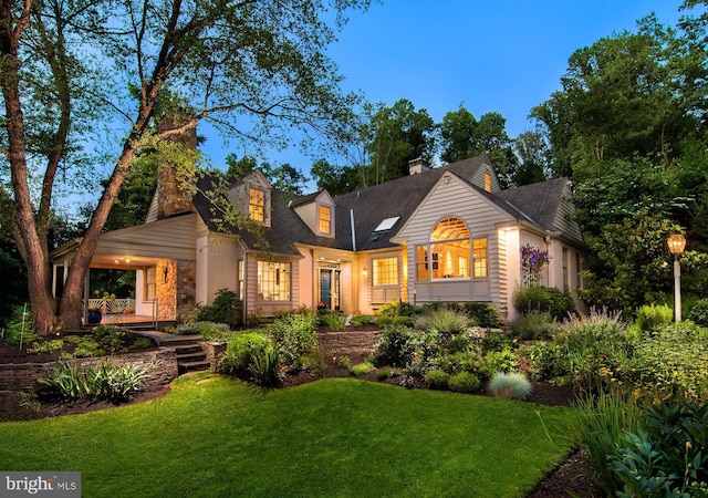 back of property featuring a yard and a chimney