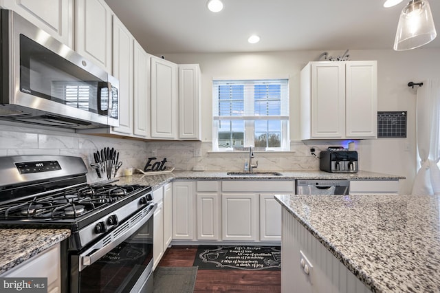 kitchen featuring white cabinets, stainless steel appliances, and sink