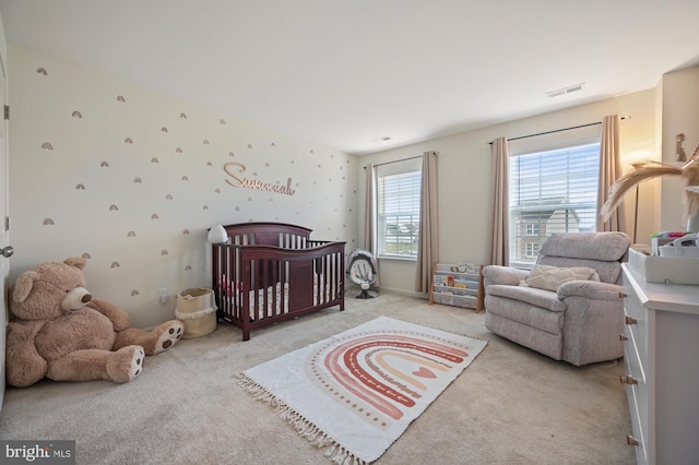 carpeted bedroom with a crib