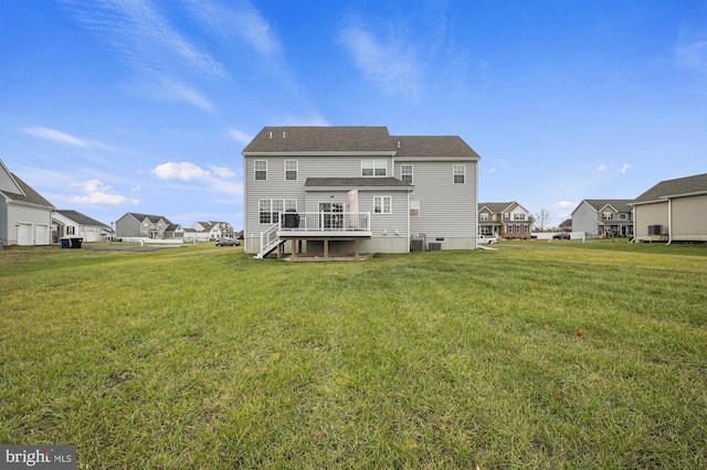 back of house with a yard, cooling unit, and a wooden deck