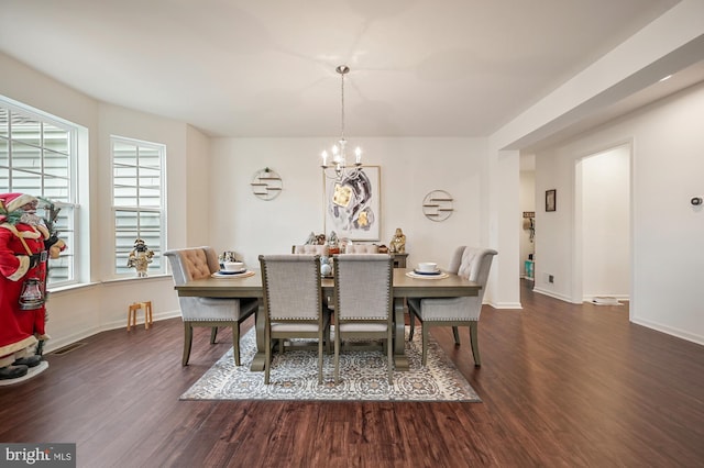 dining area featuring a chandelier and dark wood-type flooring