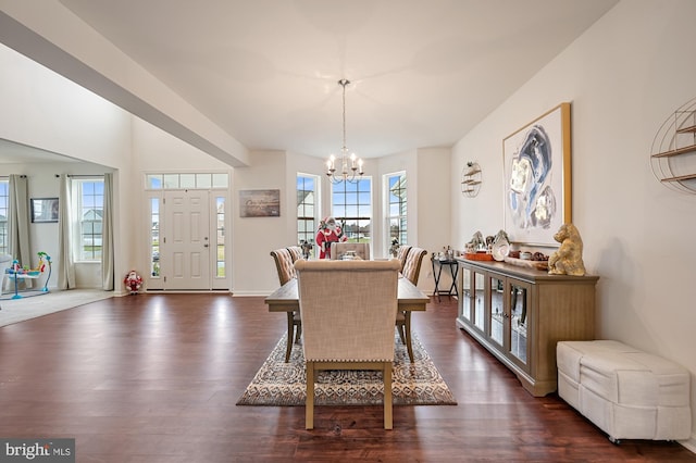 dining room with dark hardwood / wood-style floors and a notable chandelier