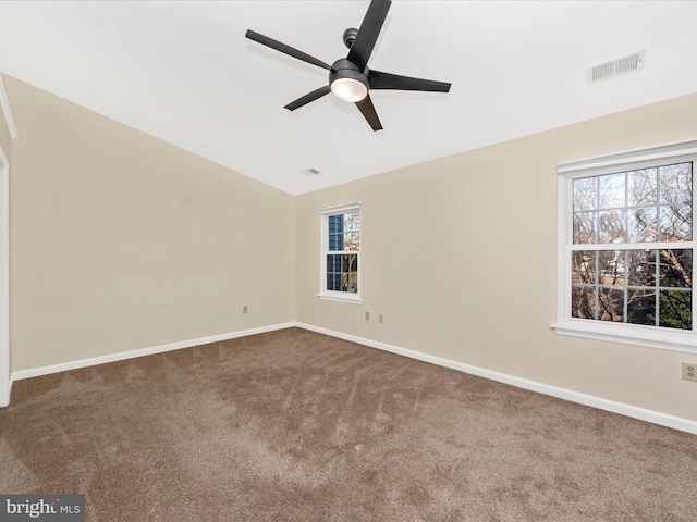 carpeted spare room with ceiling fan