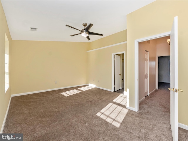 carpeted empty room with ceiling fan