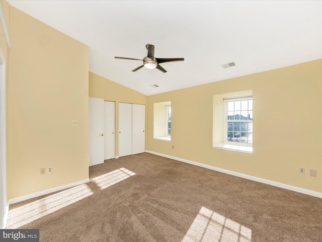 empty room with carpet, vaulted ceiling, and ceiling fan