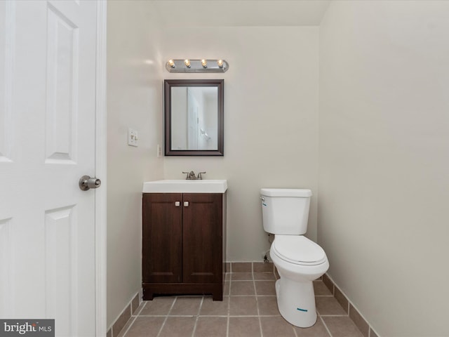 bathroom featuring tile patterned floors, vanity, and toilet