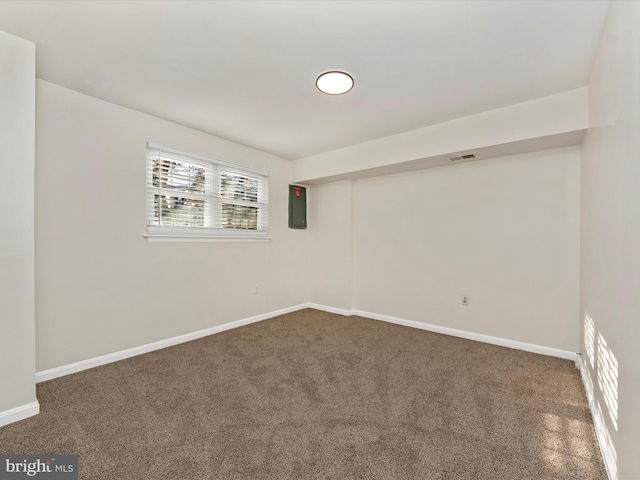 carpeted spare room with electric panel