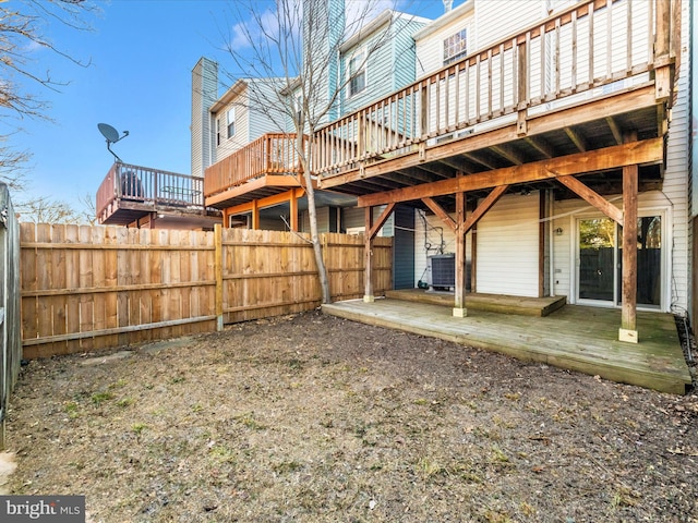 view of yard featuring central air condition unit and a wooden deck