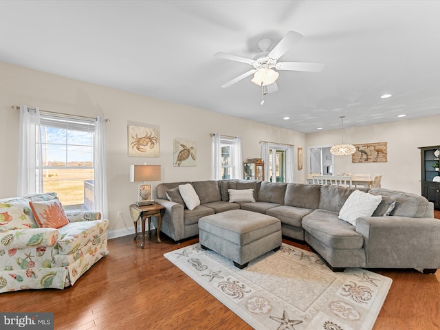 living room featuring ceiling fan and wood-type flooring