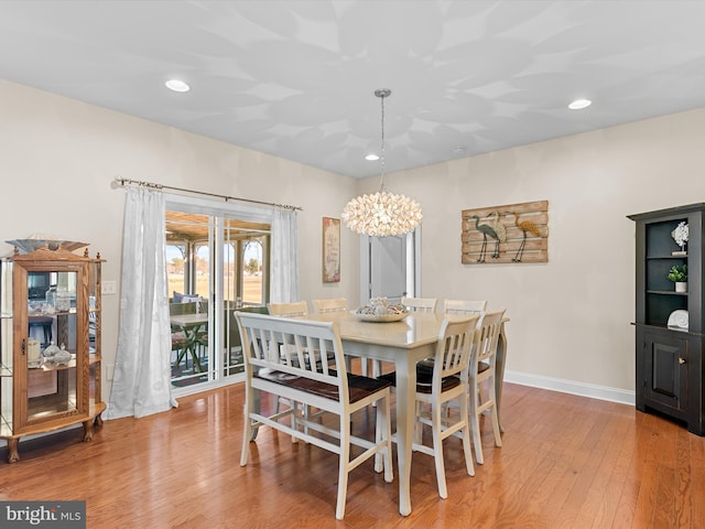 dining area featuring a chandelier and light hardwood / wood-style floors