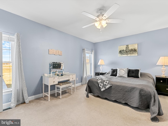 bedroom with light carpet and ceiling fan