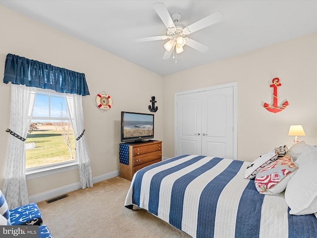 bedroom with carpet flooring, ceiling fan, and a closet