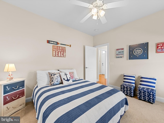 bedroom featuring light carpet and ceiling fan