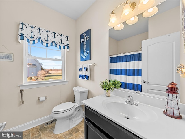 bathroom featuring vanity and toilet