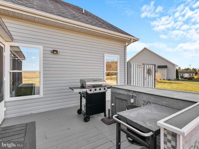 deck featuring grilling area and an outdoor bar