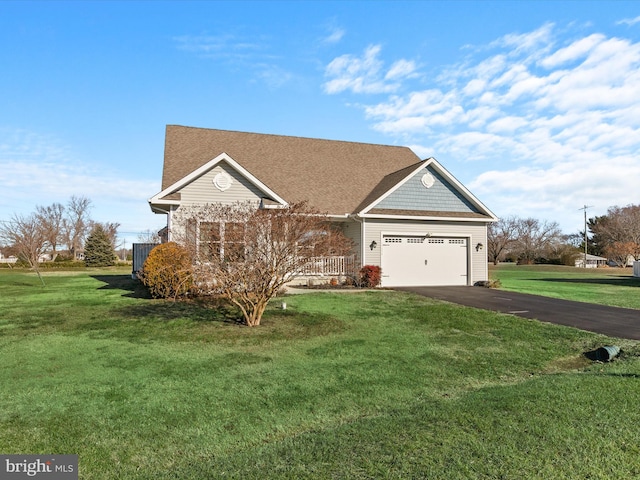 view of front of property with a front yard and a garage