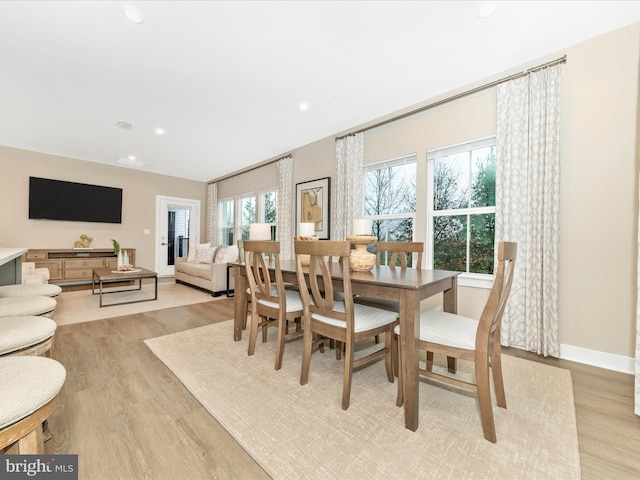 dining area featuring plenty of natural light and light wood-type flooring