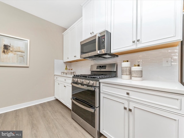 kitchen featuring white cabinetry, light hardwood / wood-style flooring, appliances with stainless steel finishes, and tasteful backsplash