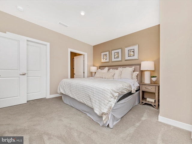 bedroom with light colored carpet