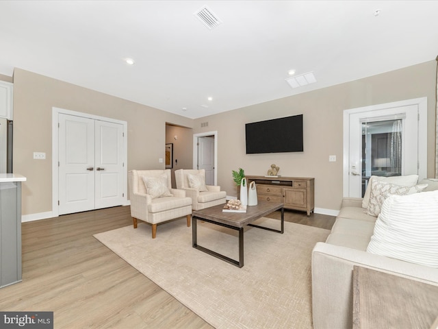 living room with light hardwood / wood-style flooring