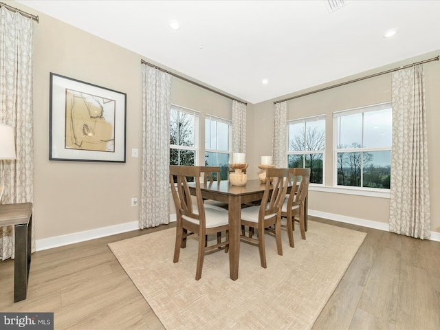 dining room featuring light wood-type flooring and a wealth of natural light