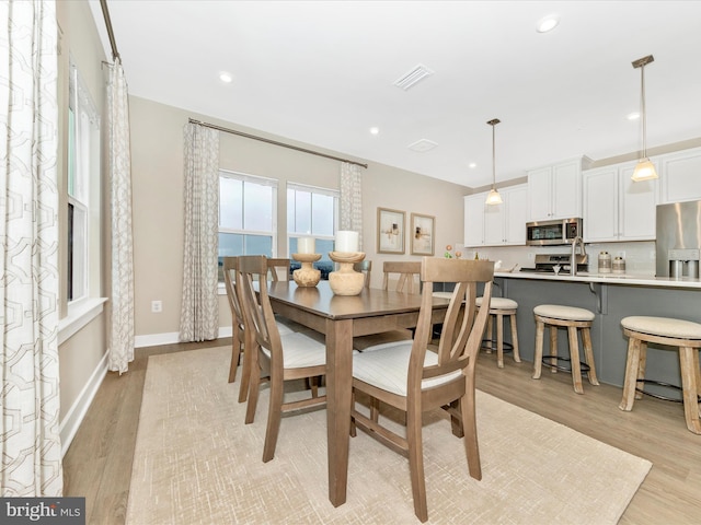 dining area featuring light wood-type flooring