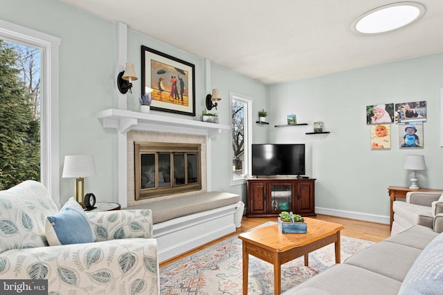 living room with a fireplace and light hardwood / wood-style floors